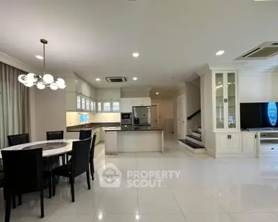 Luxurious open-plan kitchen and dining area with modern appliances and elegant lighting