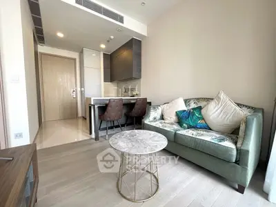 Modern living room with stylish sofa and elegant dining area in open layout apartment.