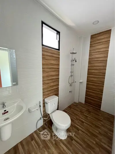 Modern bathroom with wood accent tiles and sleek fixtures