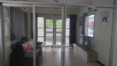 Spacious living room with modern decor and large windows for natural light.