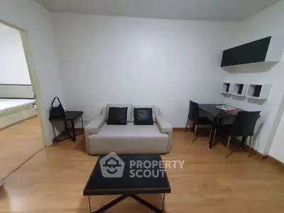 Modern living room with sleek furniture and wooden flooring, perfect for urban living.