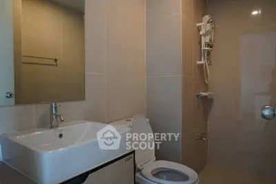 Modern bathroom with sleek fixtures and neutral tiles