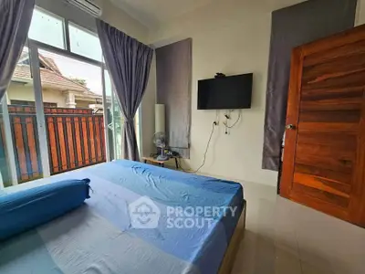 Cozy bedroom with balcony access and modern amenities in a stylish home.