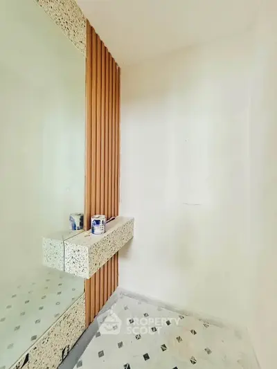 Modern minimalist bathroom with terrazzo accents and wooden paneling