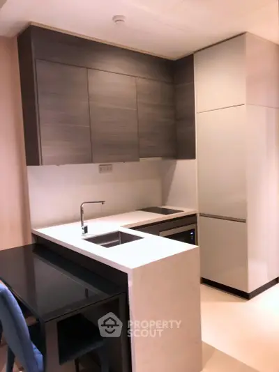 Modern kitchen with sleek cabinetry and integrated appliances in a stylish apartment.