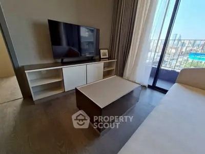 Modern living room with sleek furniture and city view balcony
