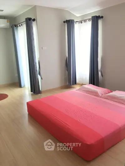 Spacious bedroom with natural light and modern decor