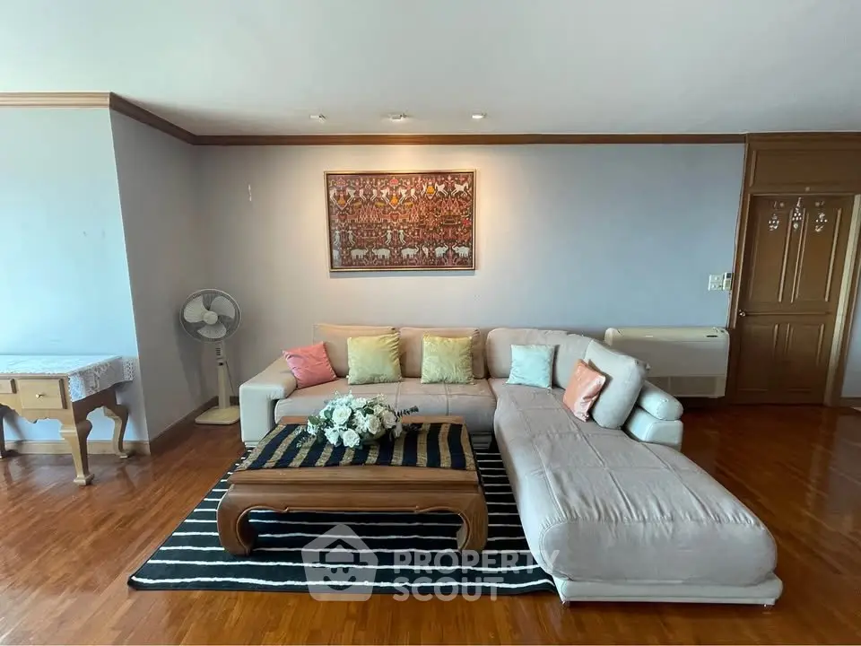 Spacious living room with elegant decor and cozy sectional sofa in a modern apartment.