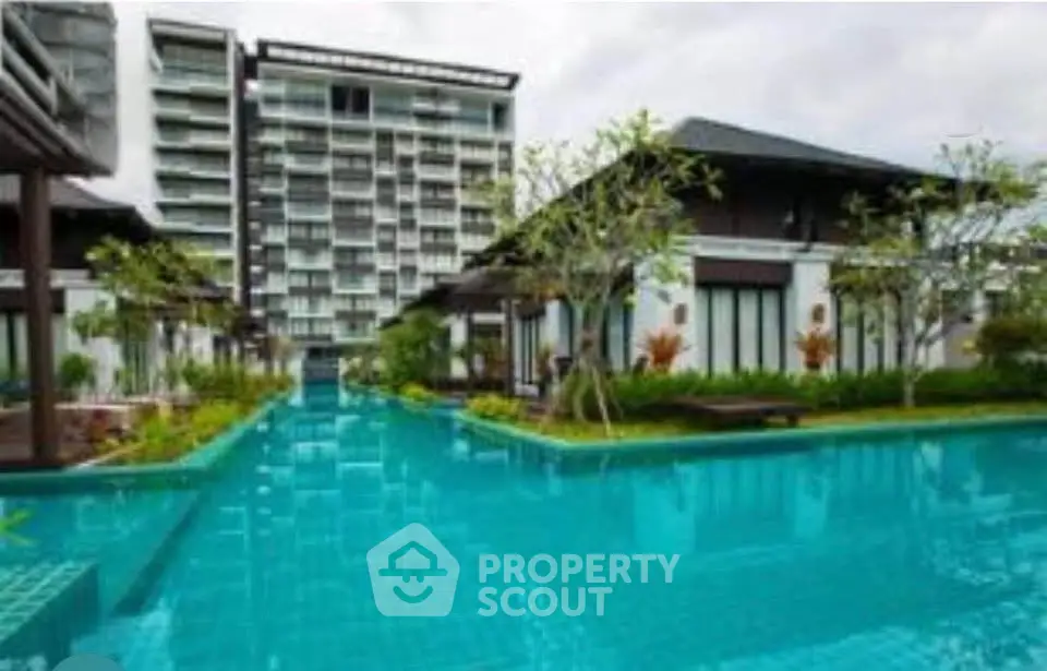 Luxurious residential complex with stunning pool and modern architecture.