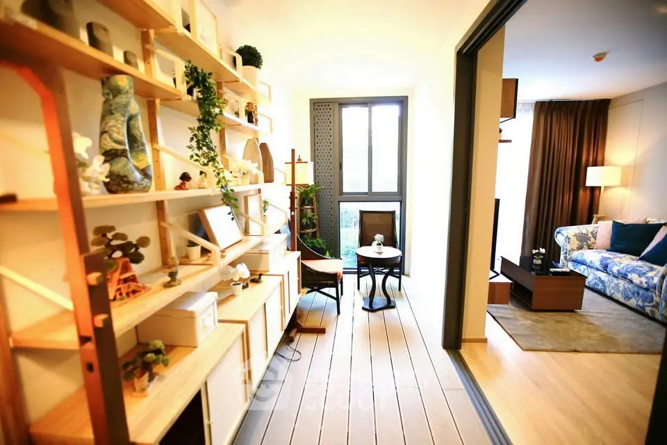 Stylish living room with open layout and elegant decor, featuring a cozy seating area and modern shelving.