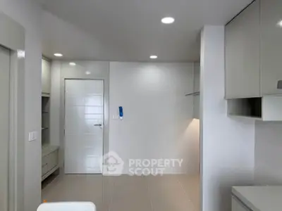 Modern minimalist interior with sleek cabinetry and neutral tones, perfect for contemporary living.