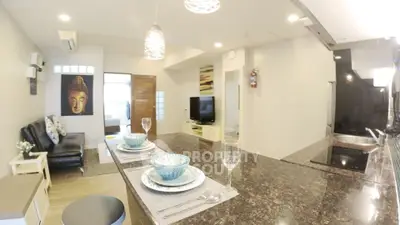 Modern open-plan living room with stylish kitchen and cozy seating area