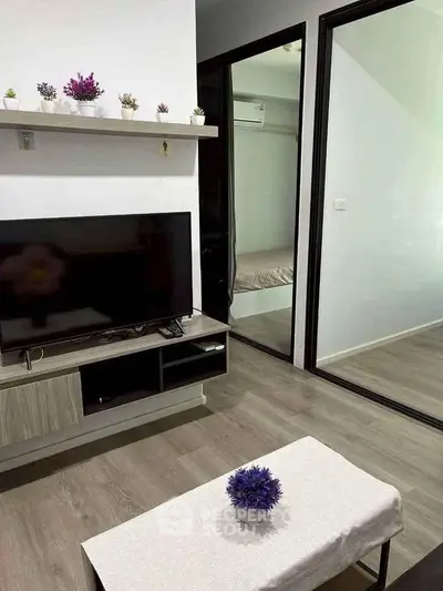 Modern living room with sleek TV stand, decorative plants, and cozy ambiance.