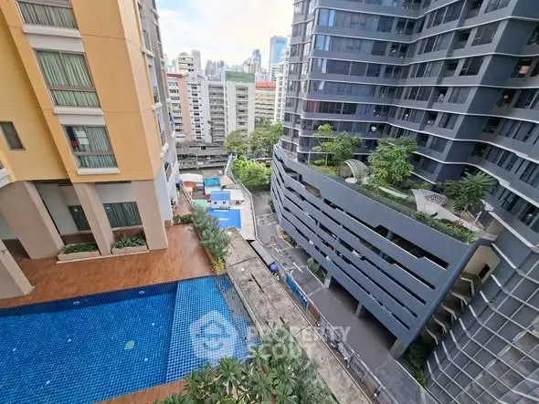 Modern urban apartment complex with pool and city view