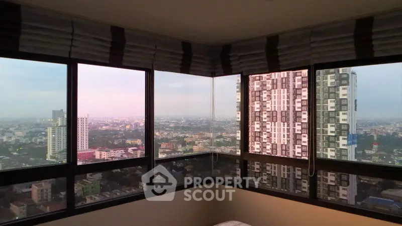Stunning panoramic city view from high-rise apartment corner unit.