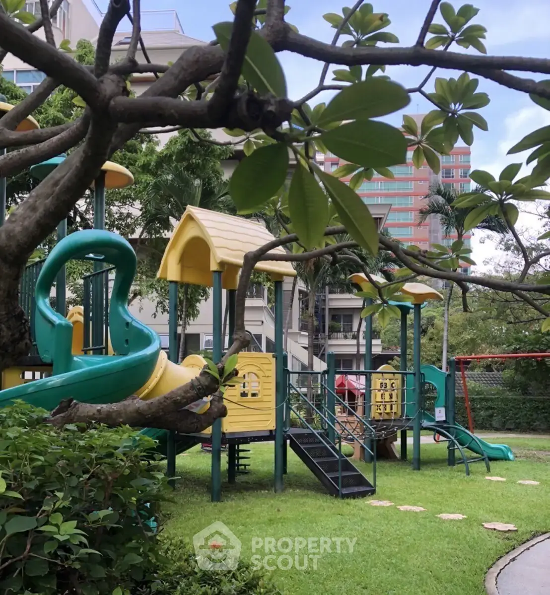 Charming residential playground surrounded by lush greenery, perfect for family-friendly living.
