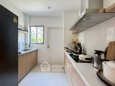 Modern kitchen with sleek cabinetry and stainless steel appliances in a bright, airy space.