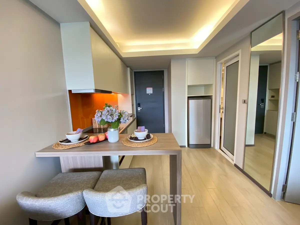 Modern kitchen with sleek design and cozy dining area in stylish apartment