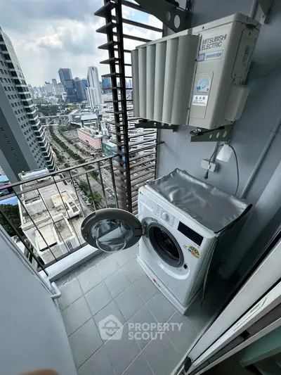 High-rise balcony with washing machine and city view, perfect for urban living convenience.