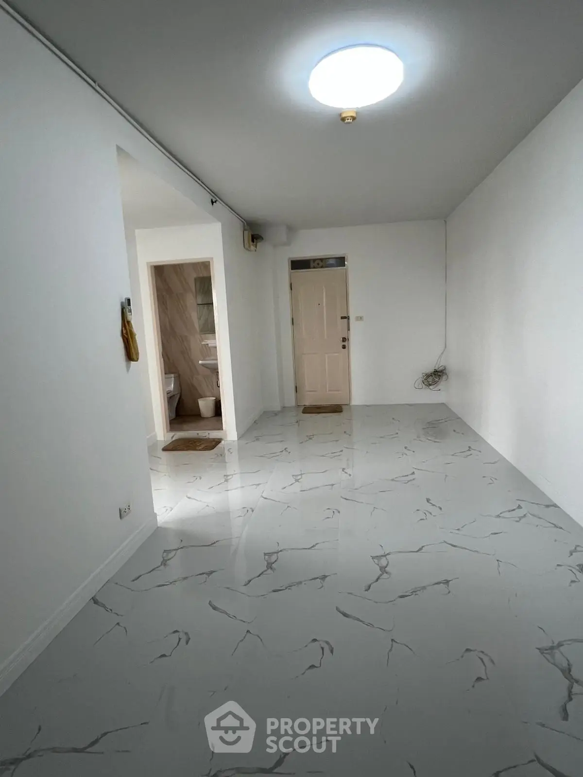 Spacious modern hallway with marble flooring and bright lighting