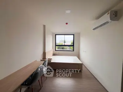 Modern minimalist bedroom with large window and air conditioning unit.