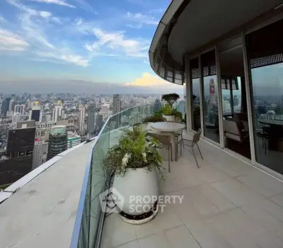 Stunning high-rise balcony with panoramic city views and modern outdoor seating.