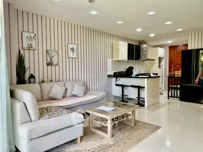 Modern open-layout living room with stylish kitchen and cozy seating area