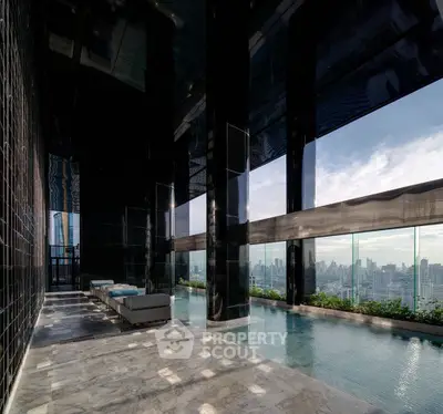 Luxurious rooftop pool with stunning city skyline views and elegant marble flooring.
