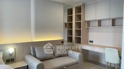 Modern study area with built-in shelves and cozy sofa in stylish apartment