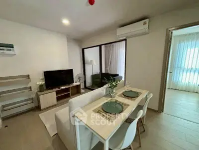 Modern living room with dining area and air conditioning in a stylish apartment.