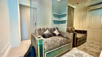 Modern living room with plush sofa and mirrored wall in stylish apartment