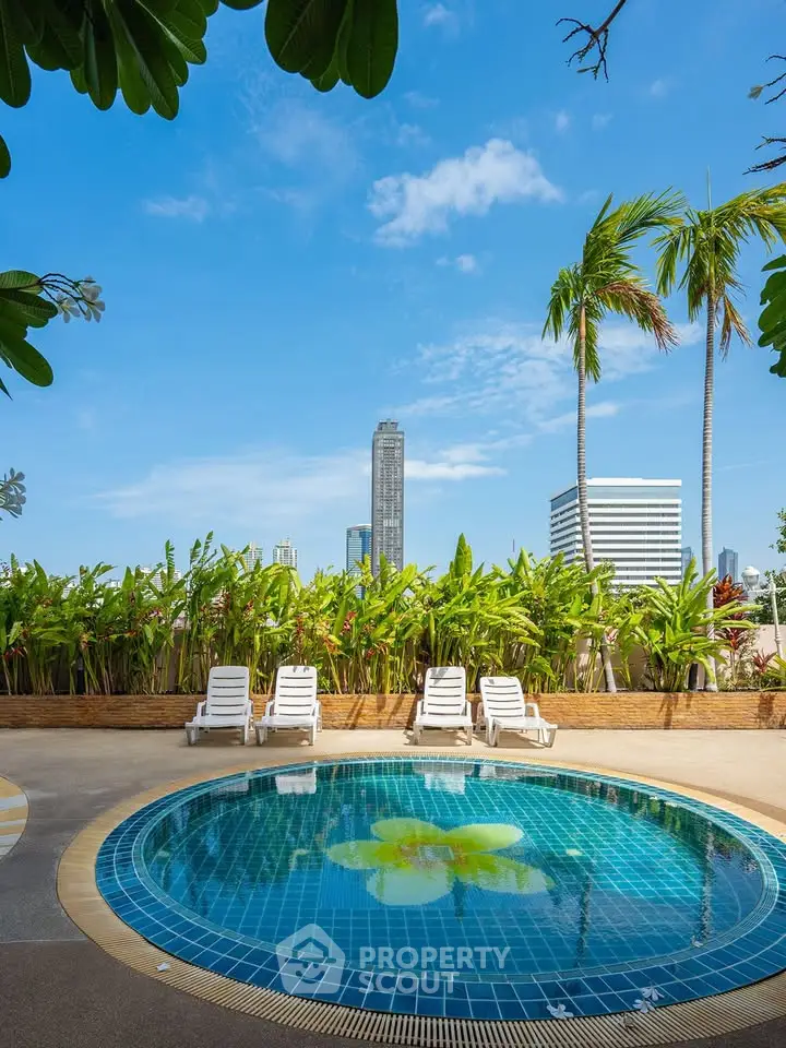 Luxurious rooftop pool with city skyline view and tropical ambiance.