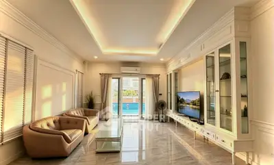 Luxurious living room with elegant furniture and pool view, perfect for modern living.