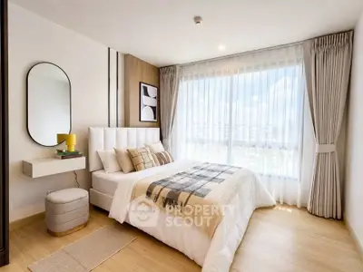 Modern bedroom with large window and stylish decor in a bright apartment.