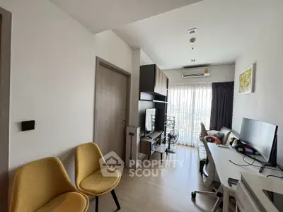 Modern living room with natural light, stylish furniture, and a cozy workspace.