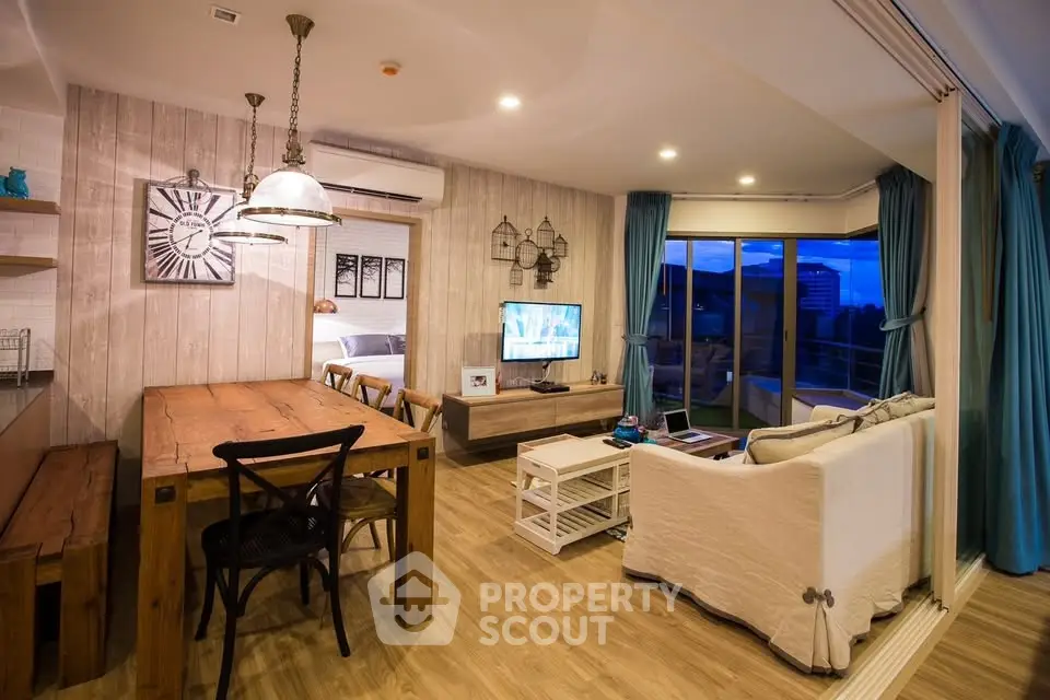 Stylish open-plan living room with modern decor and large windows offering scenic views.