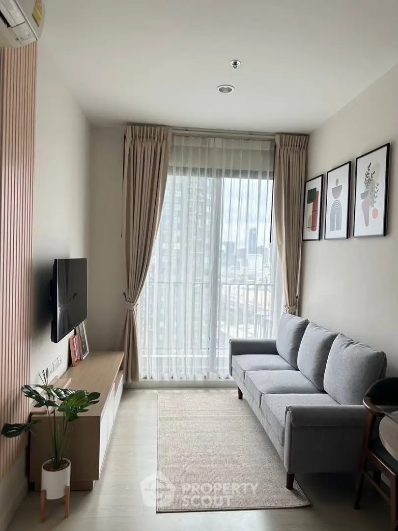 Modern living room with stylish decor and city view through large window.