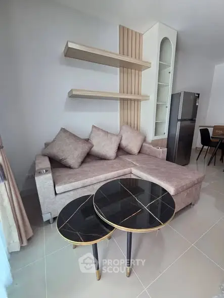 Modern living room with stylish sofa and elegant black marble coffee tables.