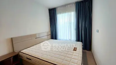 Modern bedroom with large window and elegant curtains, featuring a comfortable bed and stylish decor.