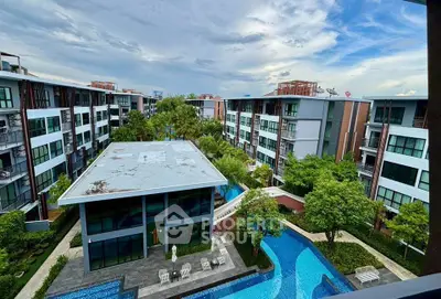 Modern residential complex with lush greenery and inviting swimming pool