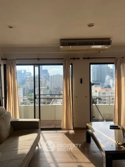 Spacious living room with city view and natural light