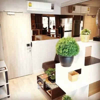 Modern living room with stylish decor and indoor plants, featuring sleek furniture and a cozy ambiance.