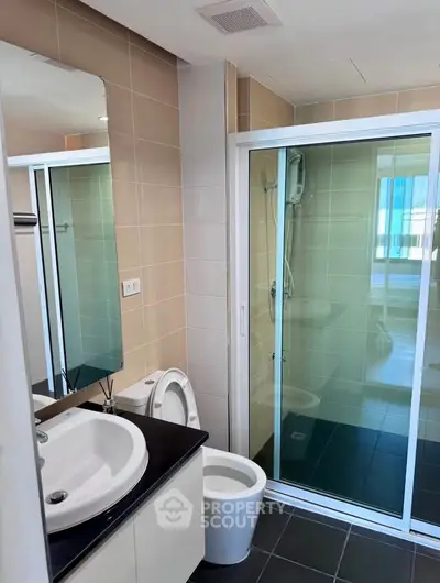 Modern bathroom with glass shower and sleek fixtures