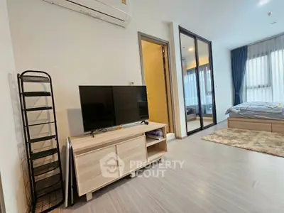 Modern apartment interior with stylish living area and cozy bedroom, featuring sleek furniture and natural light.