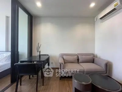 Modern living room with cozy sofa and sleek dining area in a stylish apartment.