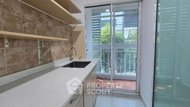 Modern kitchen with sleek design and large windows for natural light