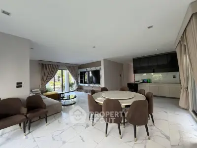 Spacious modern living room with elegant dining area and open kitchen layout, featuring luxurious marble flooring.