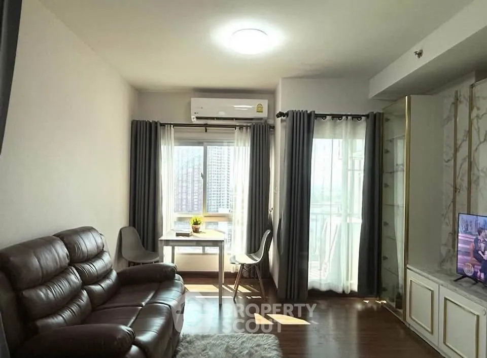 Cozy living room with leather sofa and city view, perfect for relaxation.