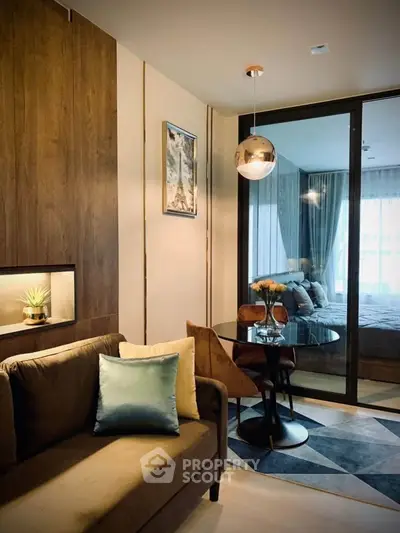 Modern living room with cozy seating and elegant dining area in stylish apartment.