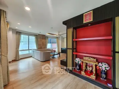 Spacious living room with modern decor and large windows